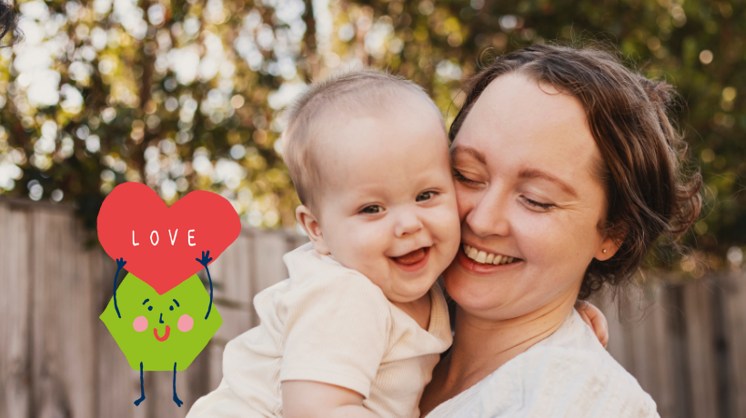 Toby and his Mum share a warm, smiley cuddle in the backyard.