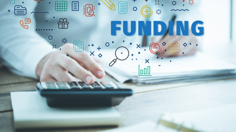 A close-up image of a person using a notepad and a calculator at a desk; there is a graphic overlay of the word 